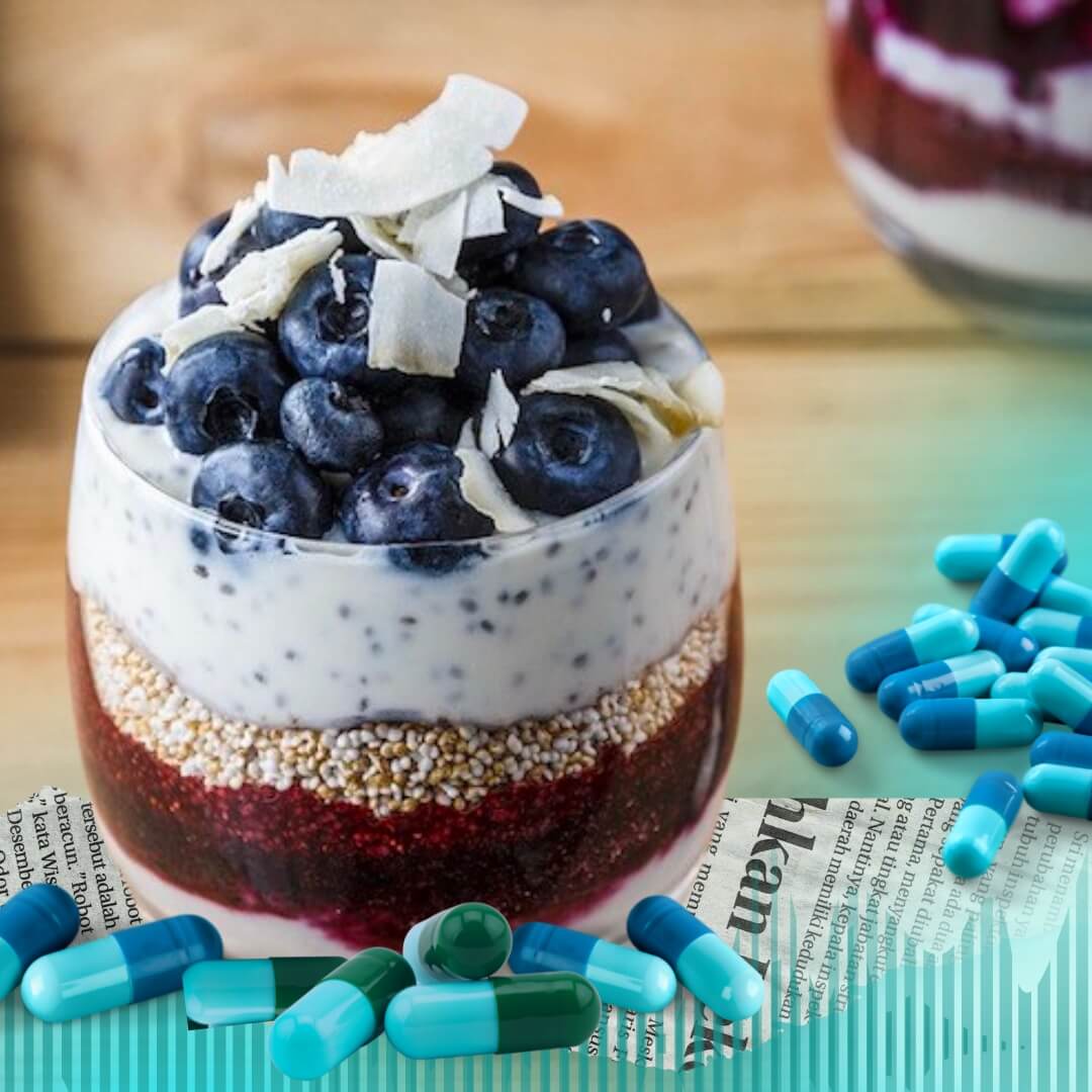 Cups of yogurt parfait surrounded by blue pills