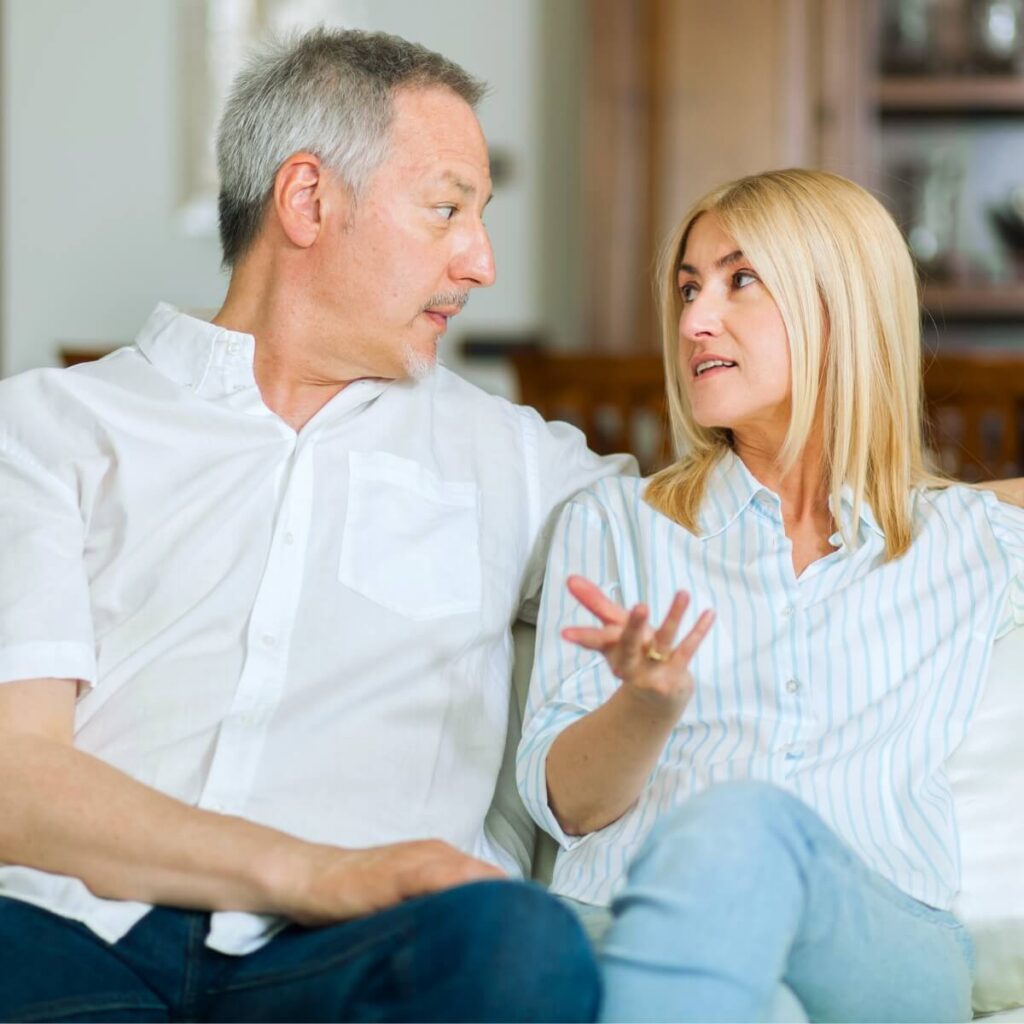 man and woman in their 40s or 50s having a serious conversation
