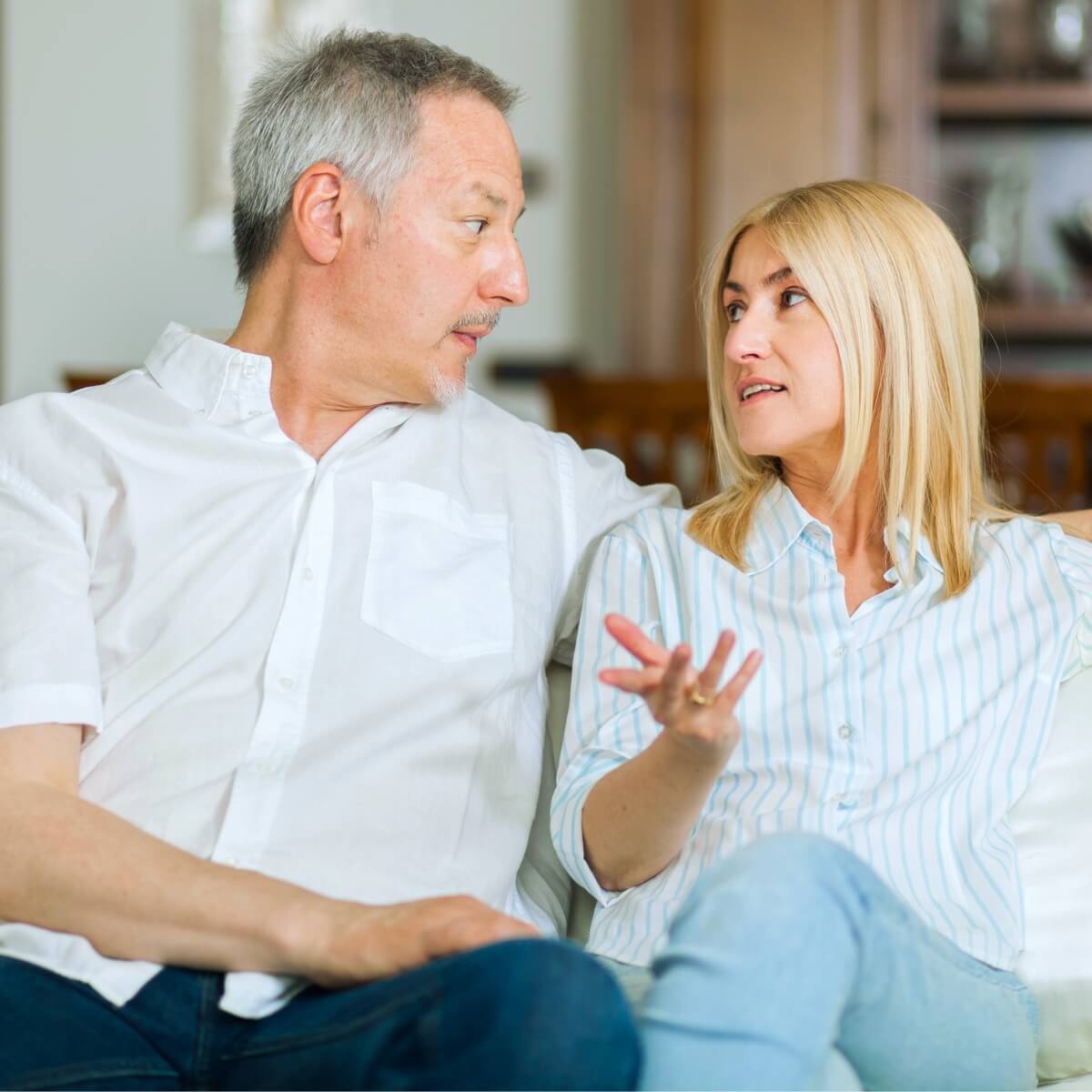 man and woman in their 40s or 50s having a serious conversation