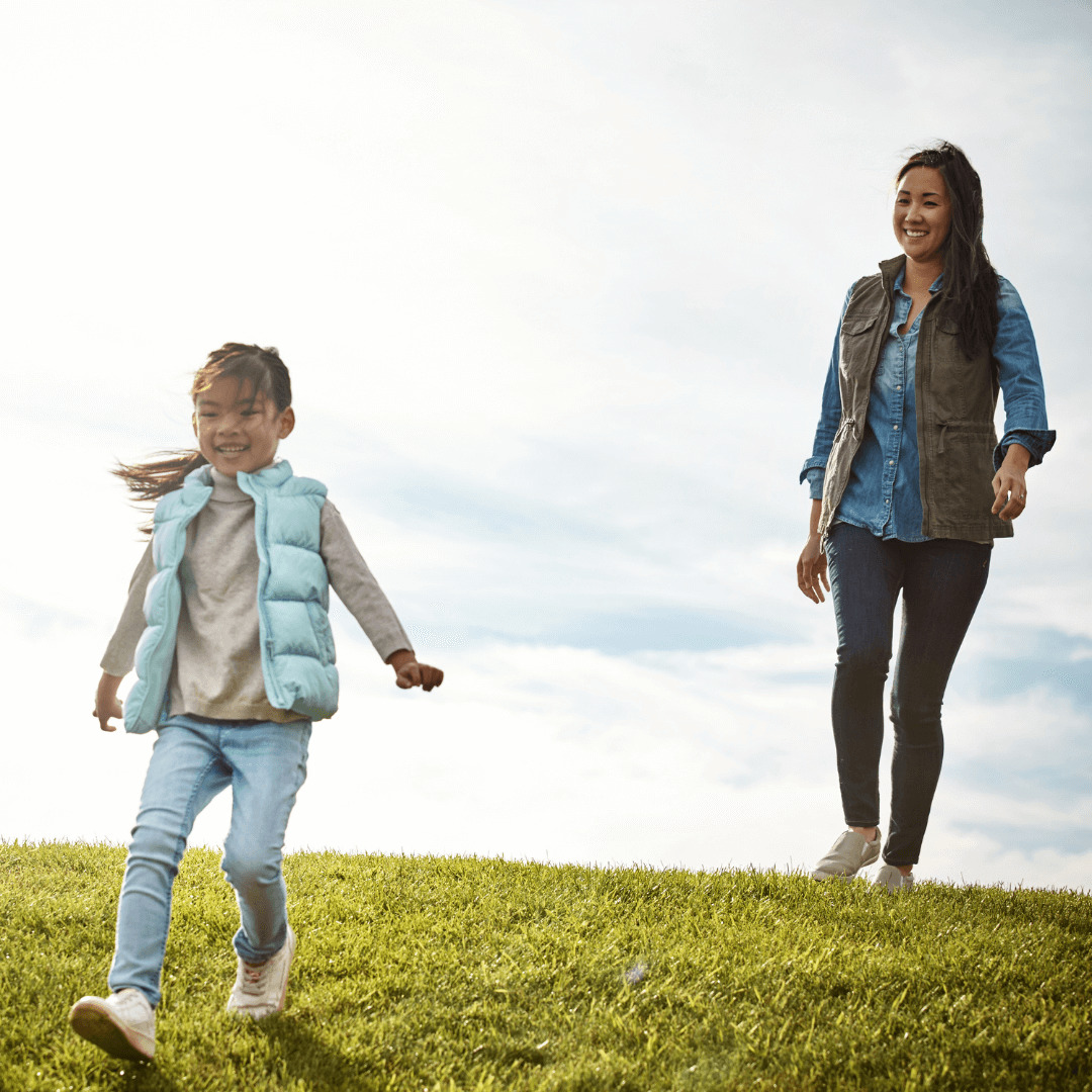 mother and daughter playing in a field