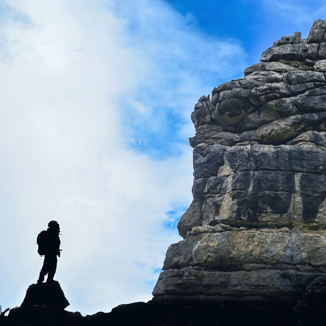Person looking at mountain before climbing it.