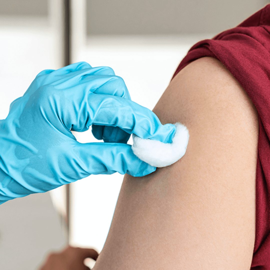 woman cleaning injection site with cotton ball