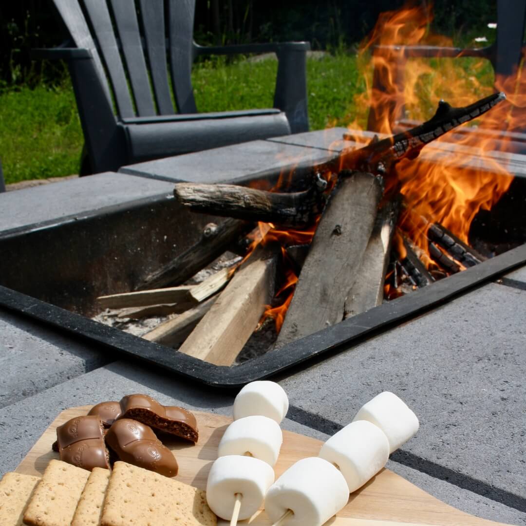 Smores on a plate next to a fire.